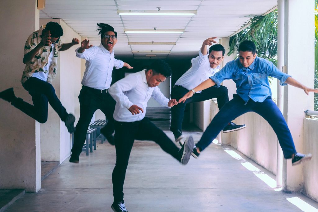 Group of employees jumping in the air