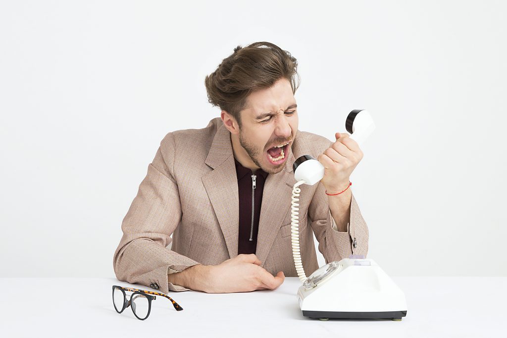 frustrated man screaming on the phone