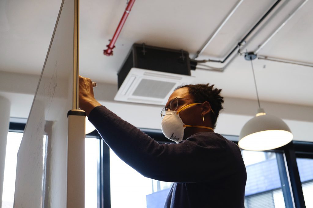 a man writing something on a whiteboard