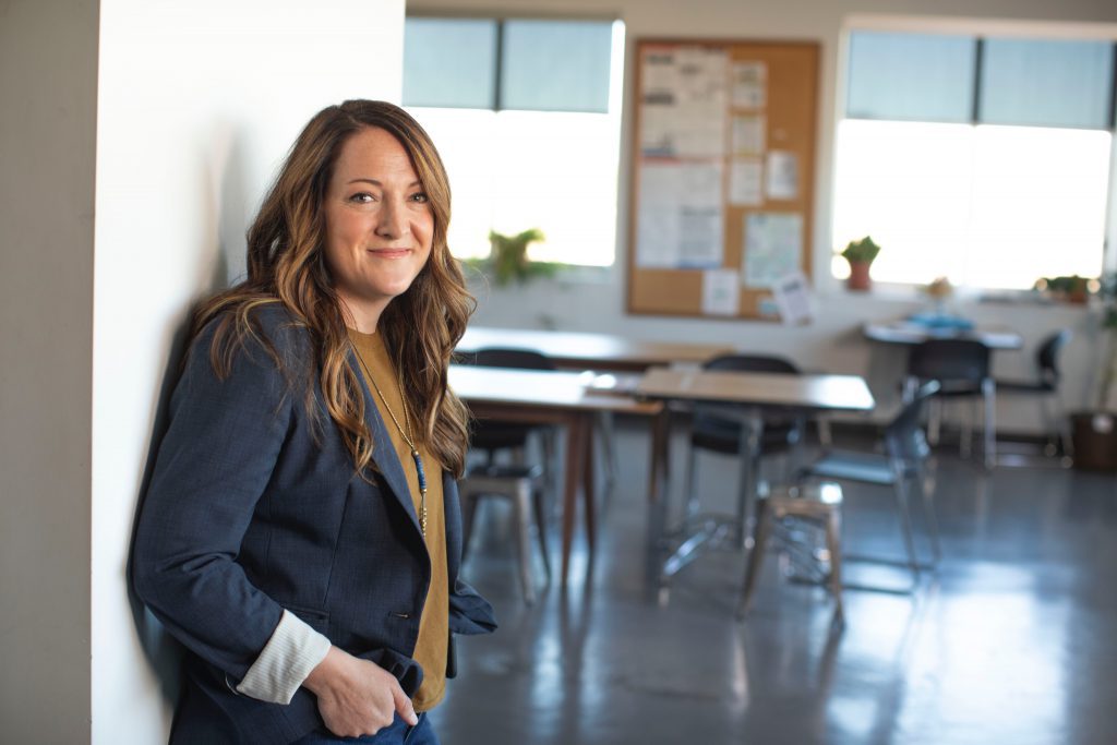 A teacher standing against the wall