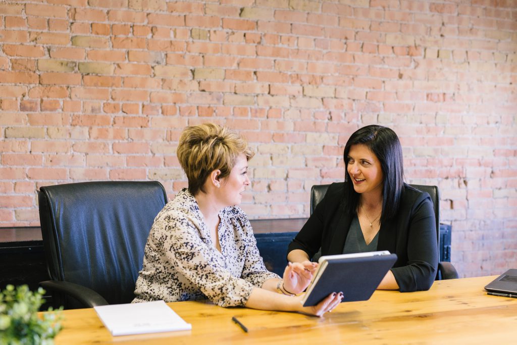 Two female employees discussing