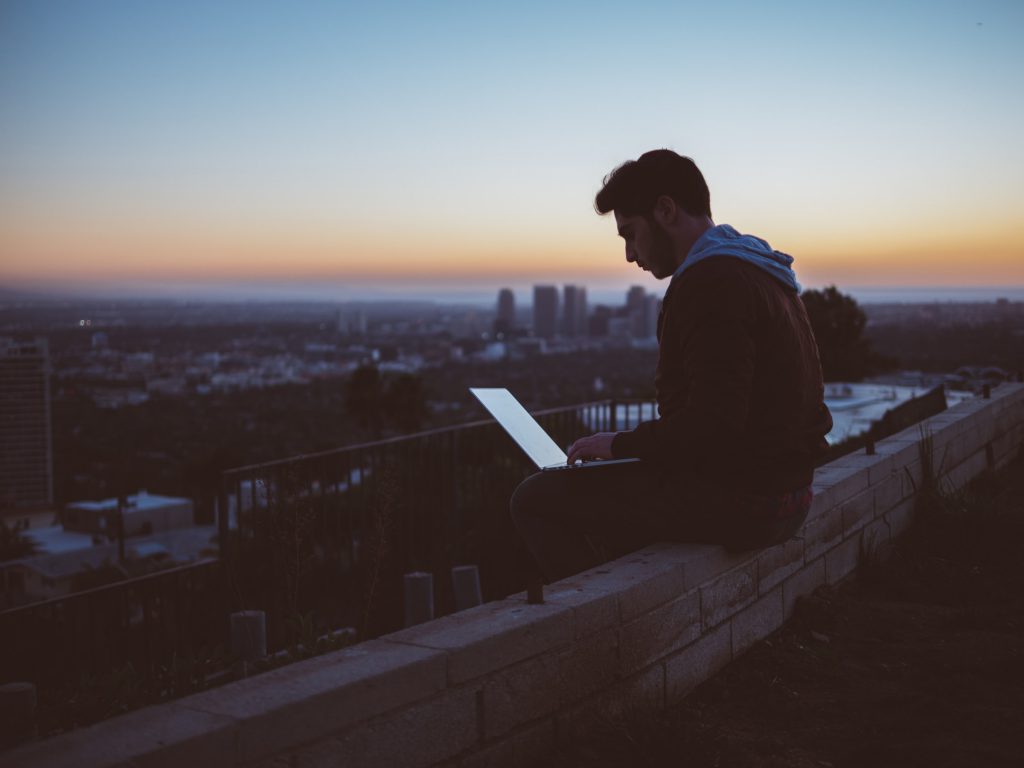 A young man using a laptop