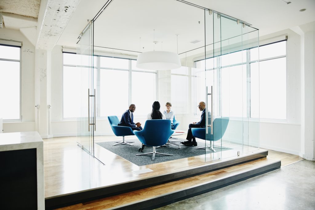 A meeting room discussion with the leader