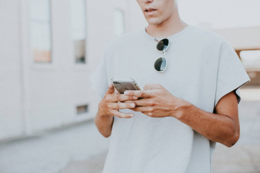 A young person checking their credit union mobile app 