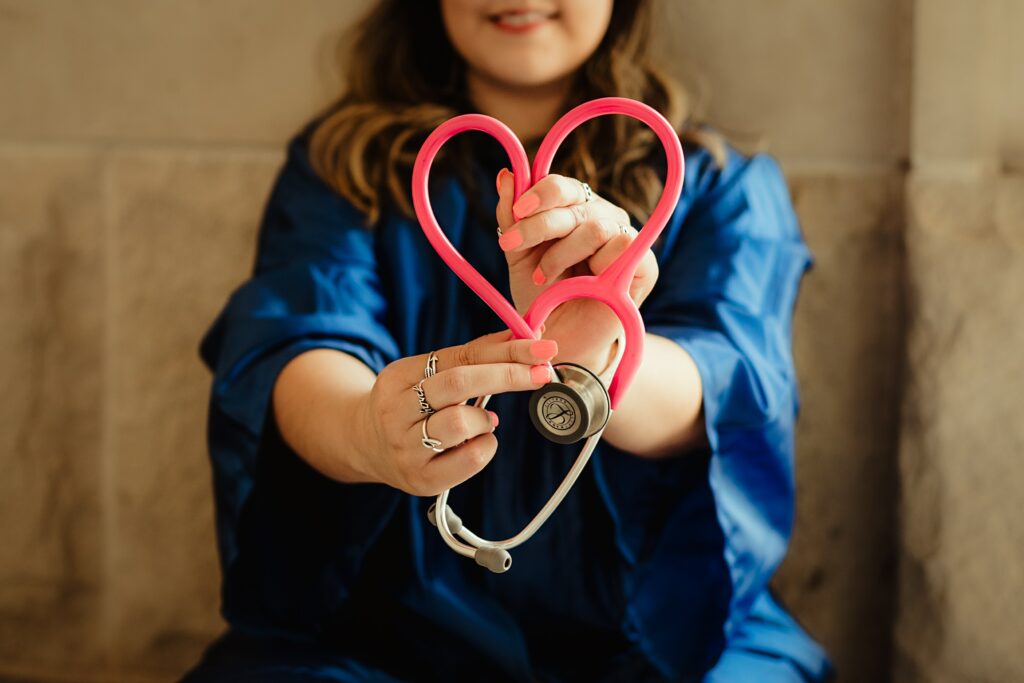 A primary care physician holds a stethoscope