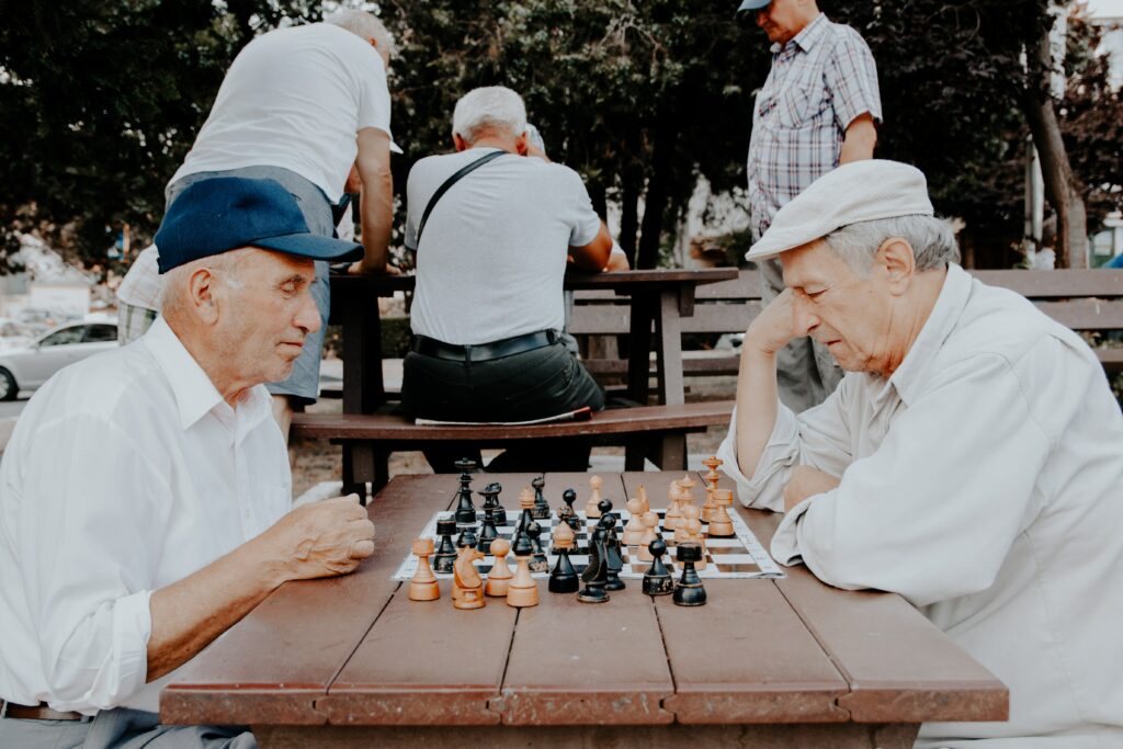 Two elderly nursing home residents play chess