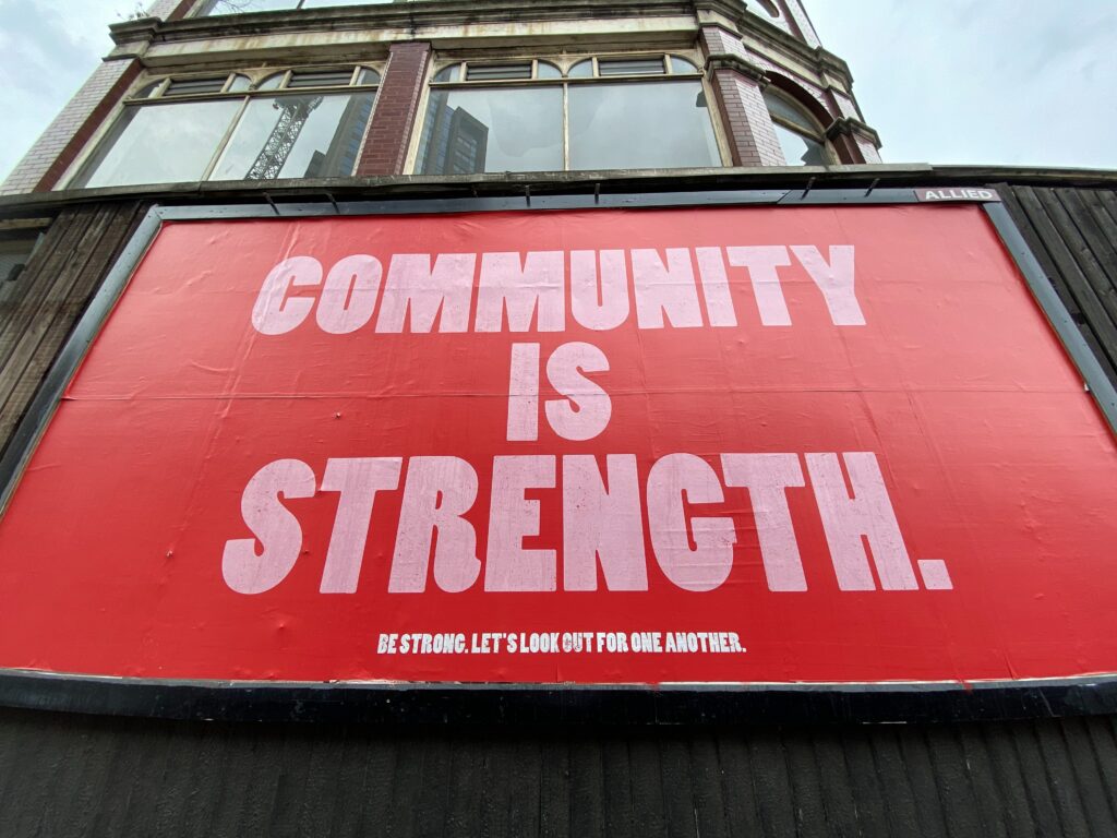 A sign that reads community is strength