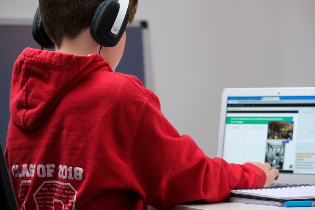 A young student uses laptop technology to learn