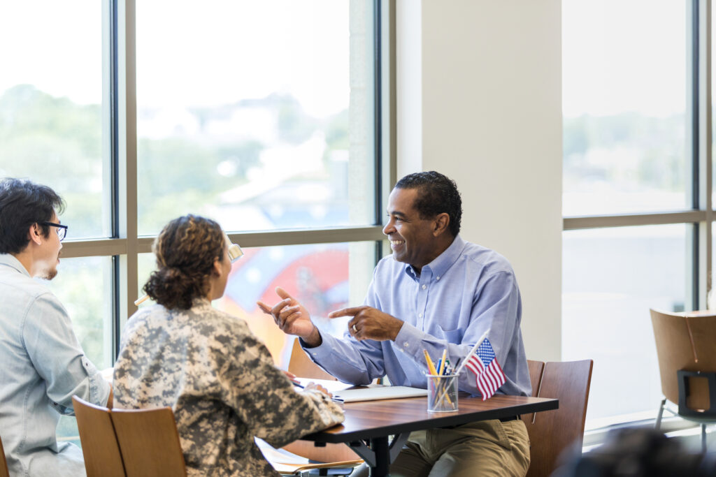 Two credit union members meet with a loan officer