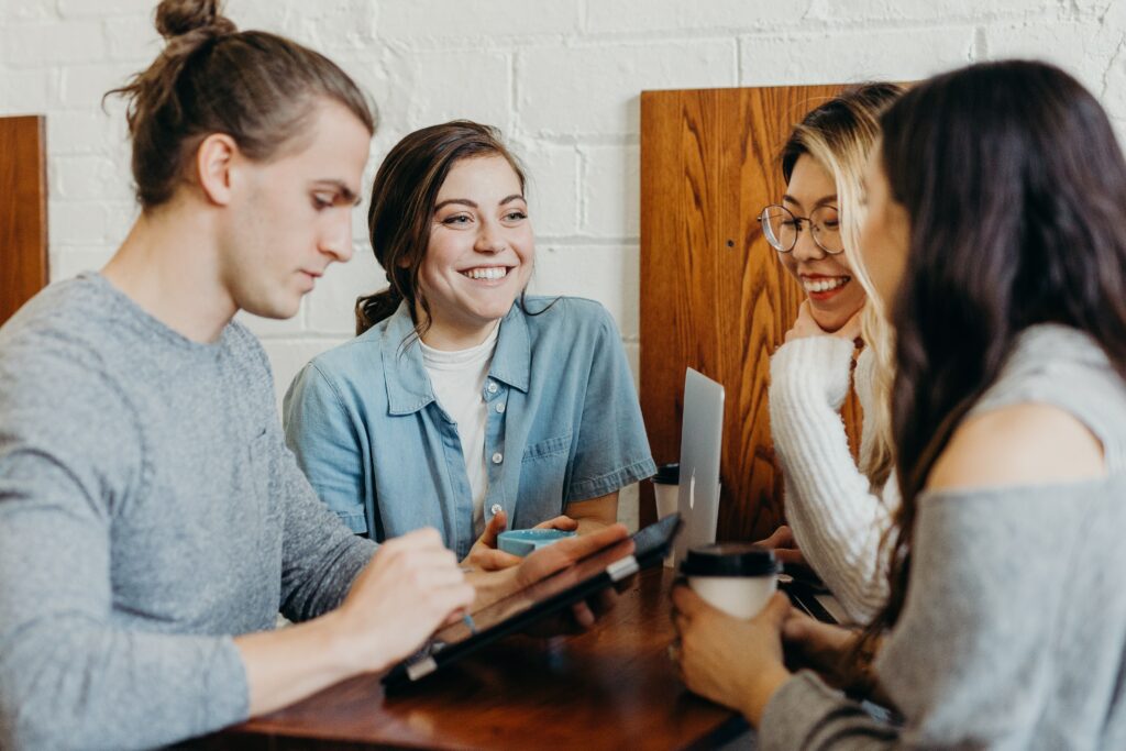 A group of smiling employees demonstrating positive corporate culture