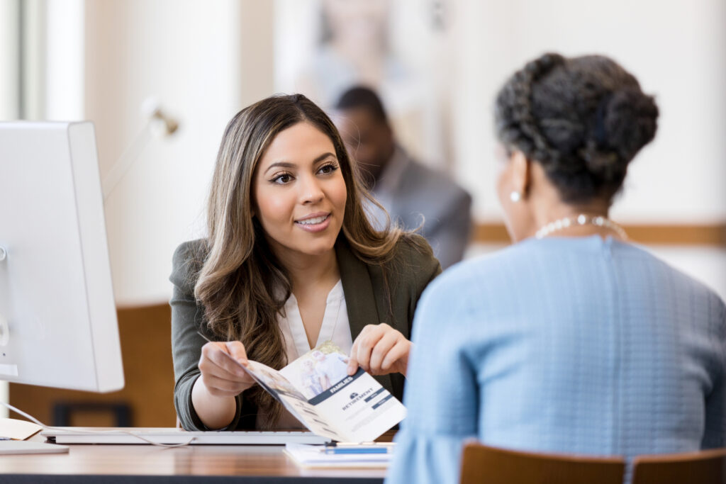 A credit union member speaks with a credit union employee