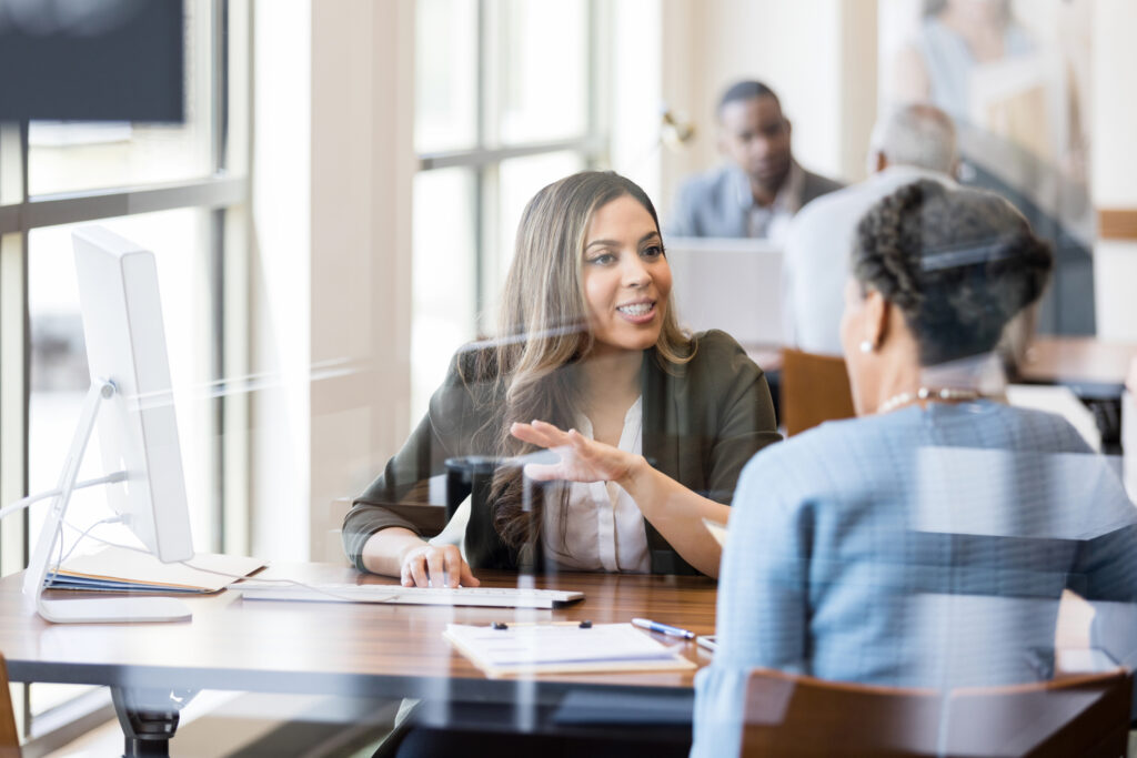 A credit union employee talks to a member