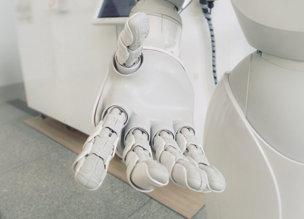 An robot hand, reaching out representing AI and people working together