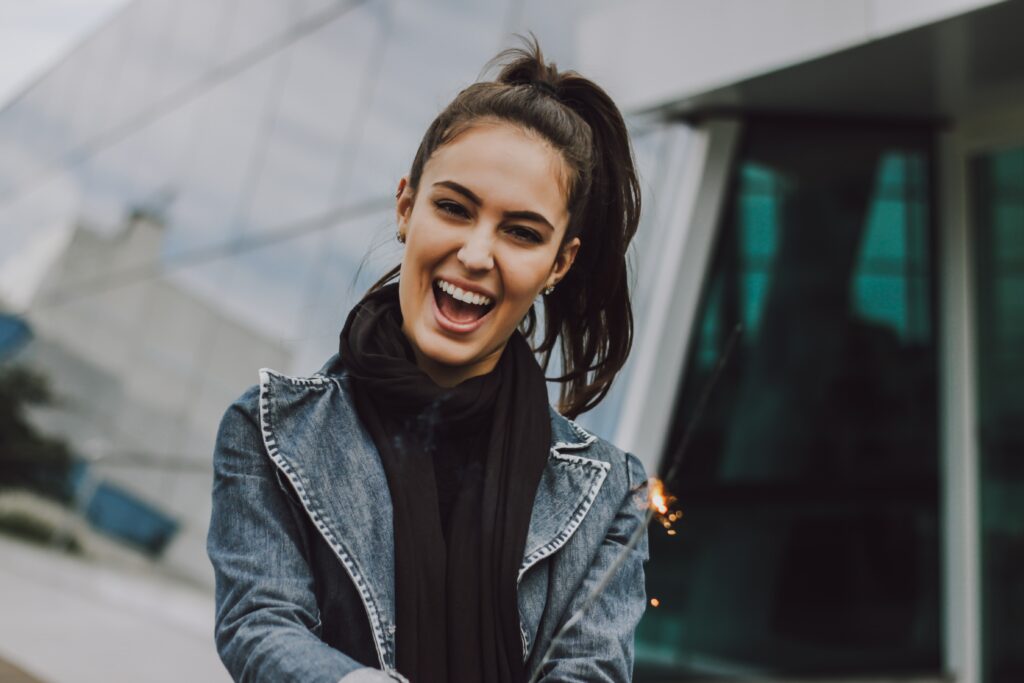 woman excited after overcoming her negative self-beliefs