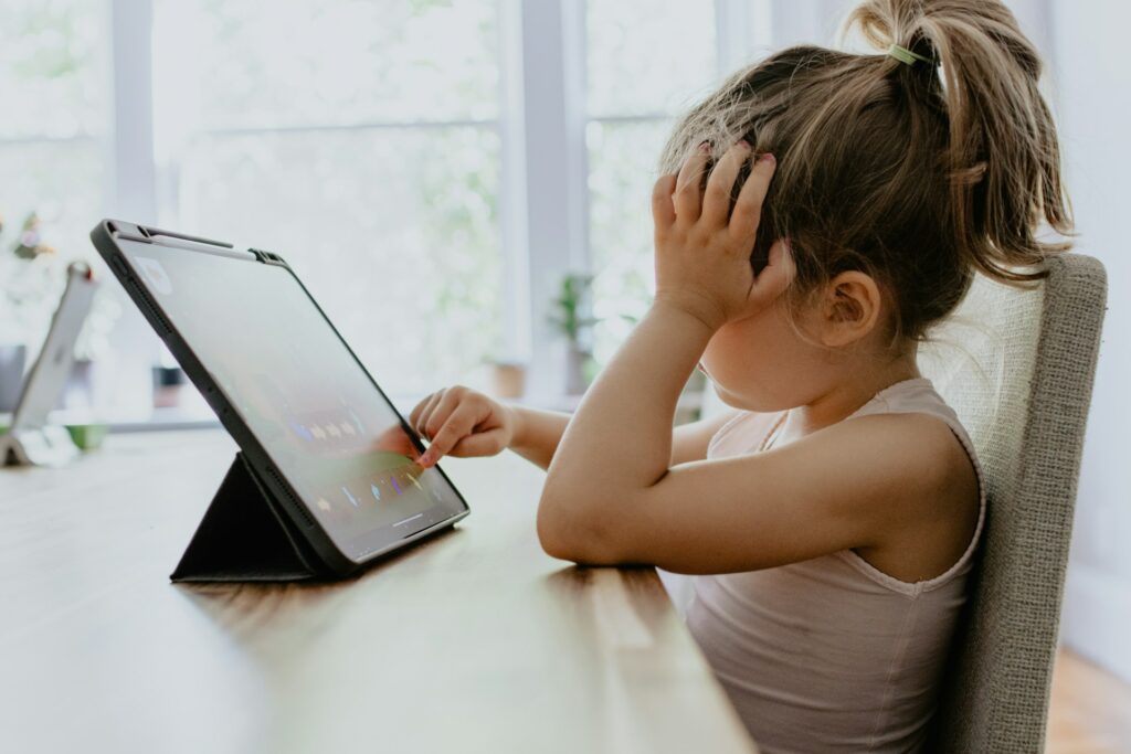 young child using social media on tablet
