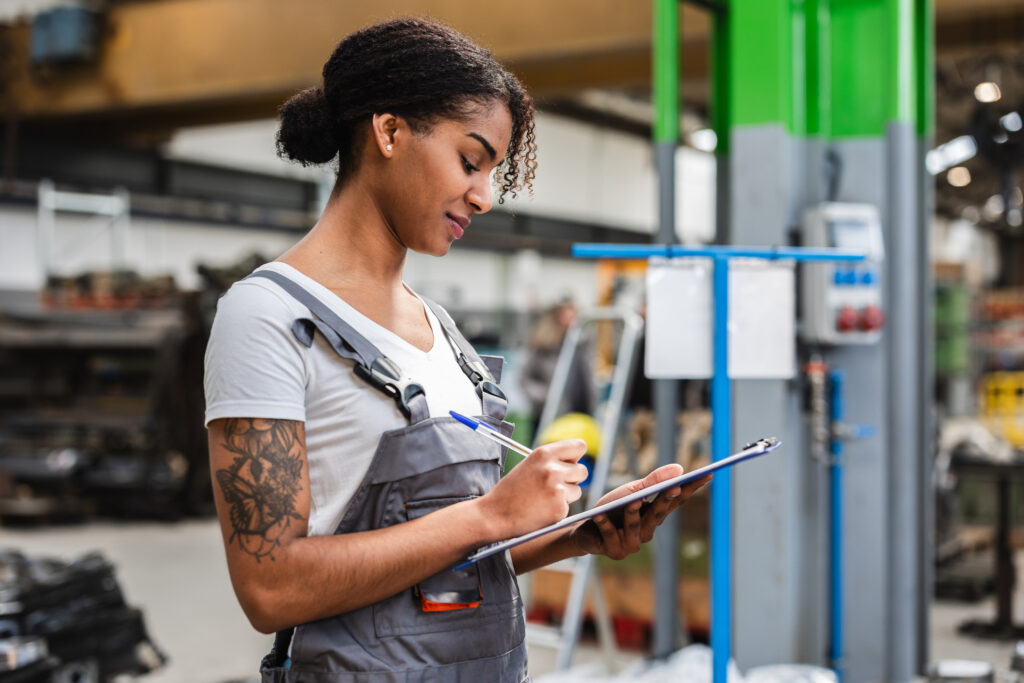 Productivity in the workplace as employee tracks on clipboard